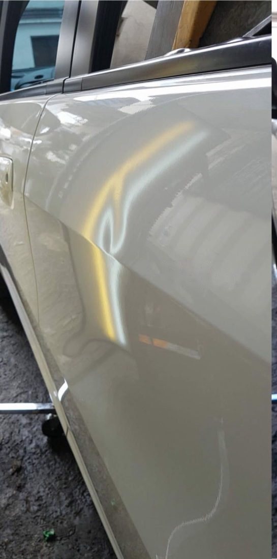 Silver door dent, before