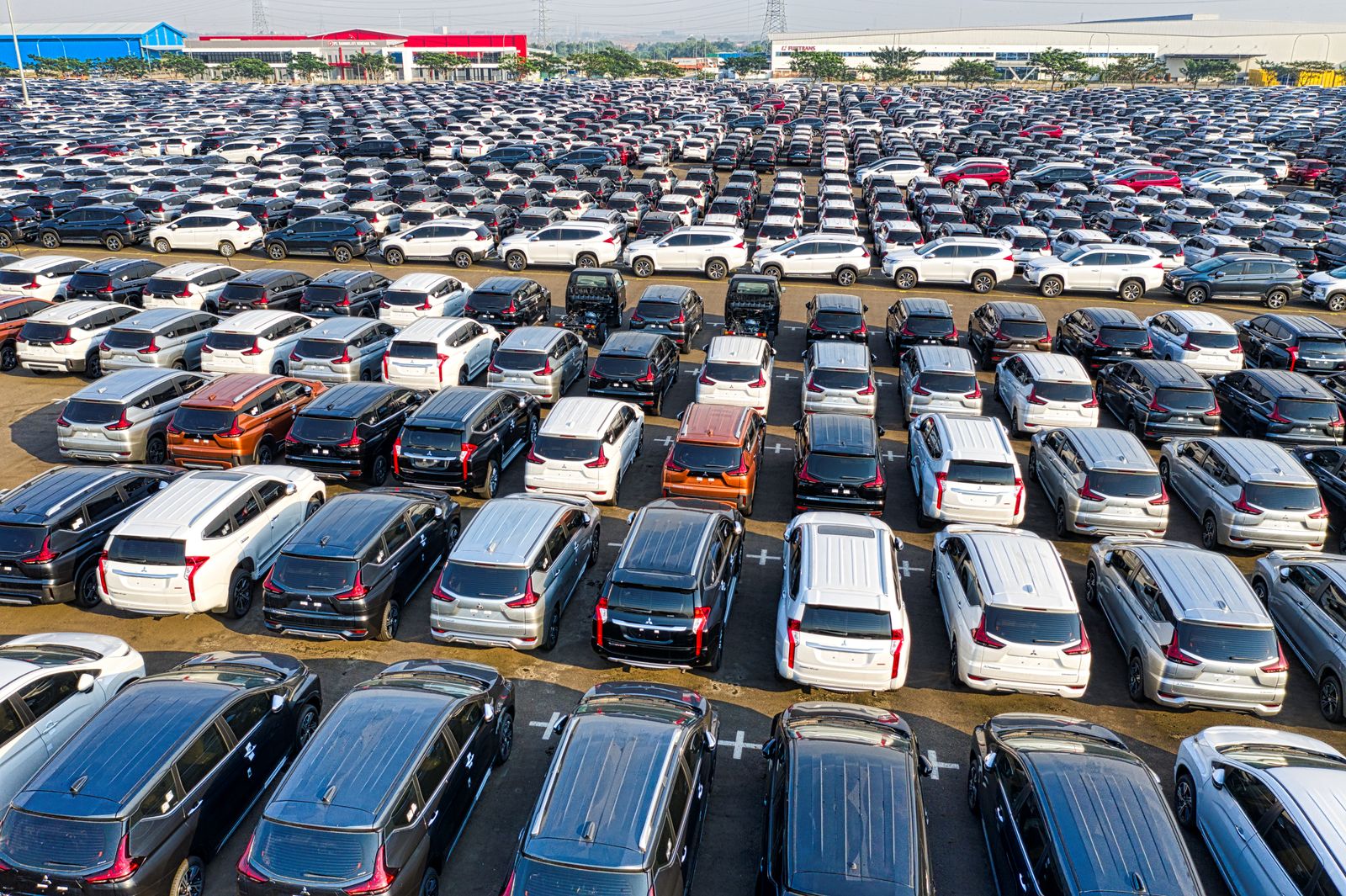 An aerial view of a large lot packed with hundreds of cars